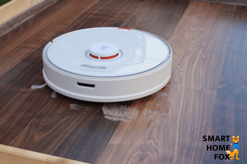 The Roborock S7 robot vacuum vacuums sand on a hard floor